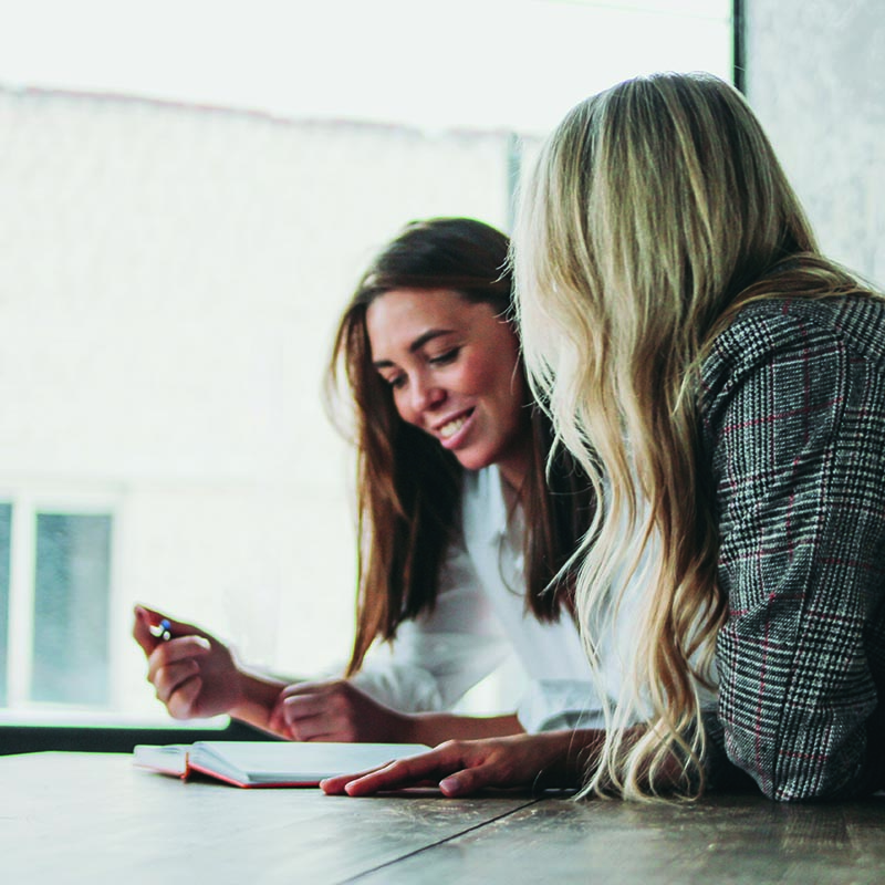 young-successful-women-colleagues-discussing case